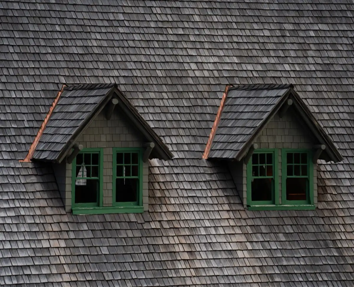 Dormers on a shingle roof in Broken Arrow, OK, where step flashing and kickout flashing carry water past the walls